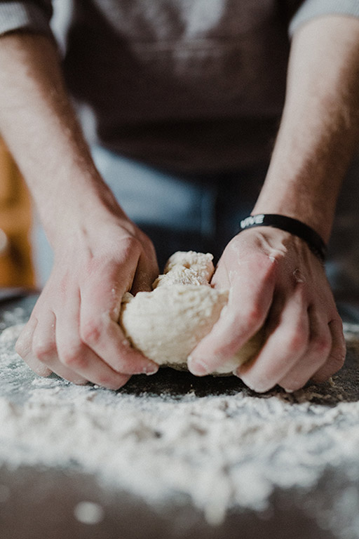 Baker kneeding fresh dough